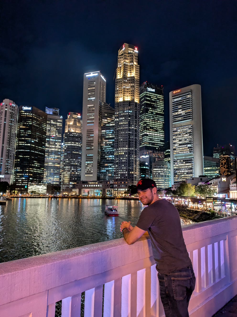 Alex Rebull, founder of Past The Click, by the Marina Bay skyline in Singapore
